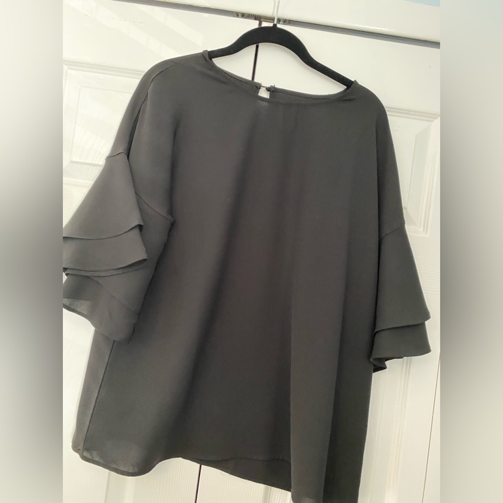 Classy & sassy. Black blouse w/ flowy short sleeves & key hole button on back.